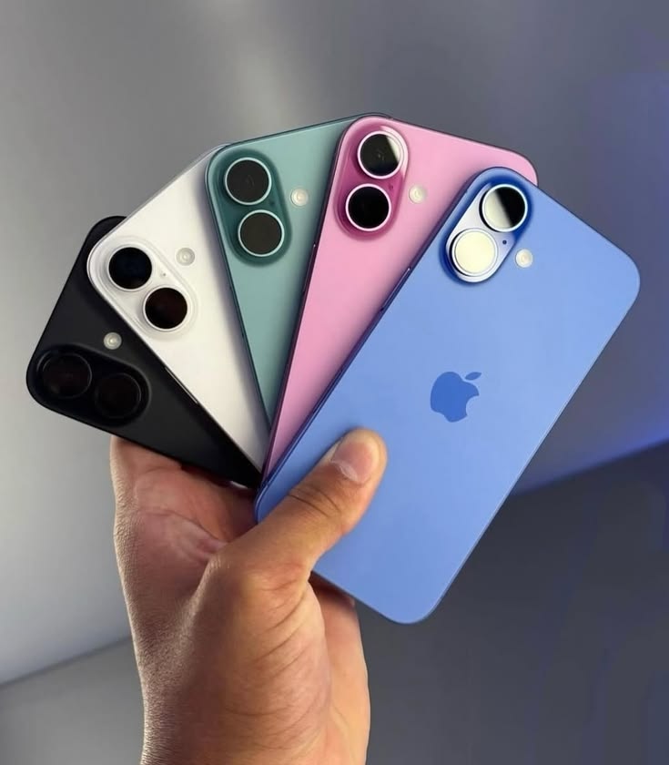Hand holding five iPhone 16 colours